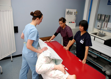 Nurses using a slider board